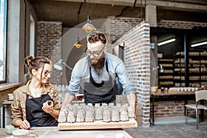 Man and woman working in the pottery shop