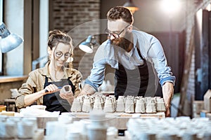 Man and woman working in the pottery shop