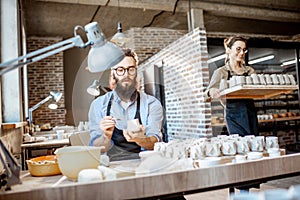 Man and woman working in the pottery shop