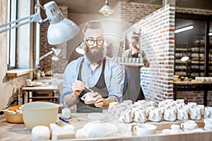 Man and woman working in the pottery shop