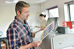 Man and woman working in printing office