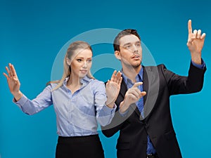 Man and woman working with something imaginary