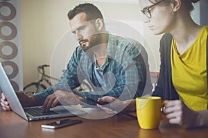 Man and woman working together with laptop