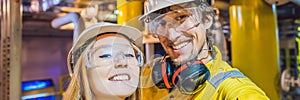 Man and woman in a yellow work uniform, glasses, and helmet in an industrial environment, oil Platform or liquefied gas