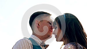 Man and woman, young happy married couple silhoutte kissing on the shore.