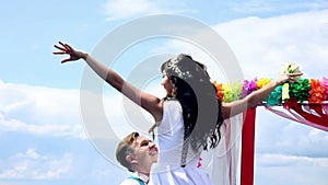 Man and woman, young people, happy married adult couple dancing near wedding arch.