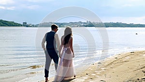 Man and woman, young people, happy married adult couple having fun and playing on the shore, beach.