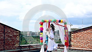 Man and woman, young people, happy married adult couple standing near wedding arch.