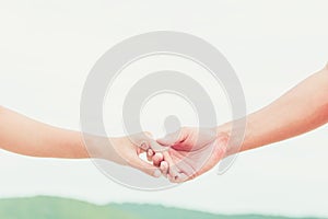 Man and the women hold one`s hand on the  beach