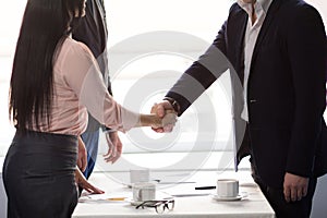 Three business people sign agreement at restaurant photo