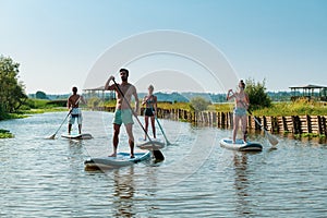 Man and women stand up paddleboarding