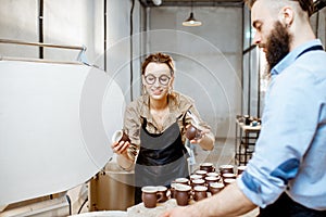 Man and woman working with ceramics at the pottery