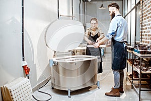 Man and woman working with ceramics at the pottery