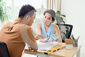 Man and woman working together in an architect office