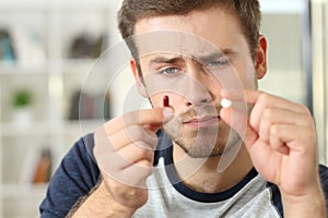 Man wondering about pill or capsule photo