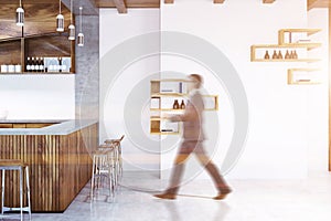 Man in a wooden bar interior, toned