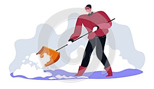 Man with wooden shovel cleaning snow in winter