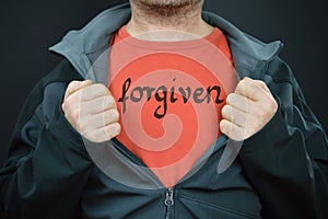 A man with the word forgiven on his t-shirt