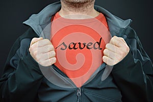 A man with the word saved on his t-shirt