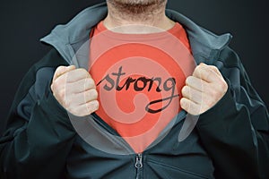 A man with the word strong on his t-shirt