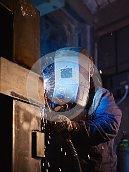 Man at work as welder in heavy industry