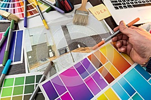 Man work with Color palette and house apartament sketch for creative design home photo