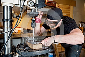 Man in work on electric drill press