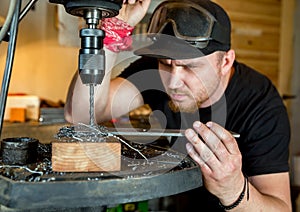 Man in work on electric drill press