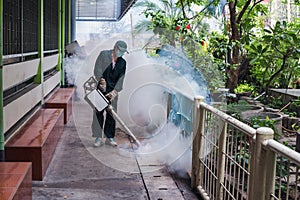 Man work fogging to eliminate mosquito for preventing spread dengue fever and zika virus