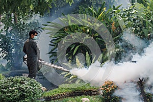 Man work fogging to eliminate mosquito for preventing spread dengue fever and zika virus