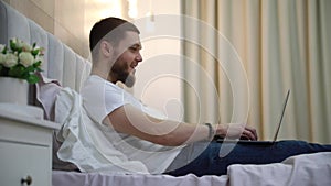 man work on laptop at home in bed