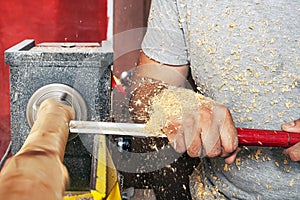 Man work on the lathe wood