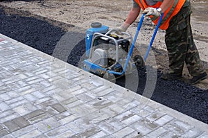 Man work with Vibratory plate compactor