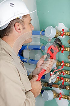 man worker adjusting water meter