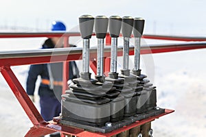 Man worker in a boom lift, machine control on the aerial platform