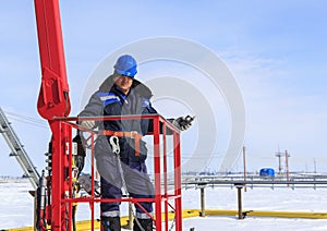 Man worker in a boom lift, machine control on the aerial platform