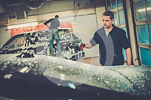 Man worker on a car wash