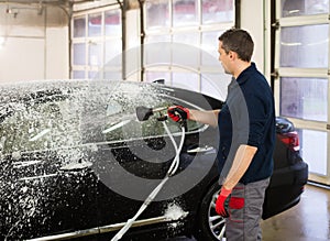 Man worker on a car wash