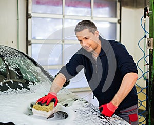 Man worker on a car wash