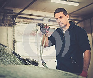 Man worker on a car wash