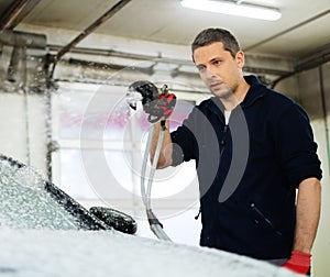 Man worker on a car wash