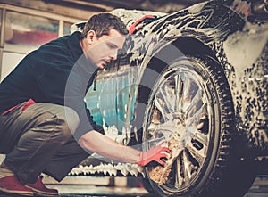 Man worker on a car wash