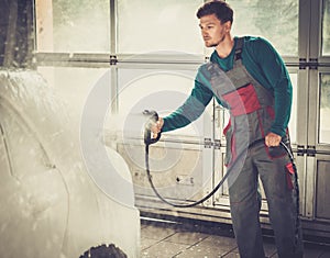 Man worker on a car wash