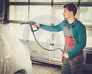 Man worker on a car wash