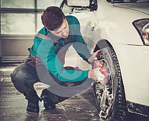 Man worker on a car wash