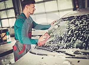 Man worker on a car wash