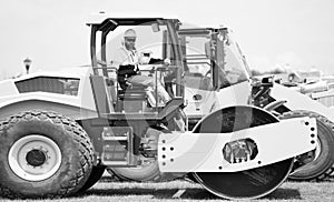 man worker at construction machinery outdoor. man construction worker used vibratory roller. busy worker man on