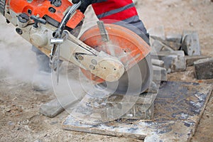 Man worker cutting concrete circular tool diamond blade