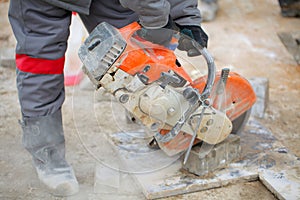 Man worker cutting concrete circular tool diamond blade