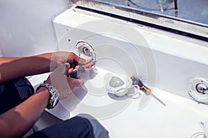 A man worker fixes socket in the wall